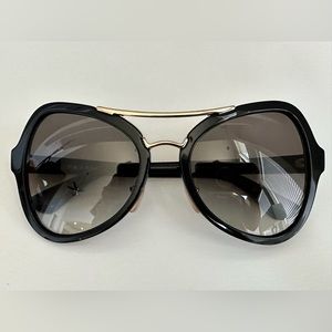 Black Prada sunglasses with Gold detailing and logo.